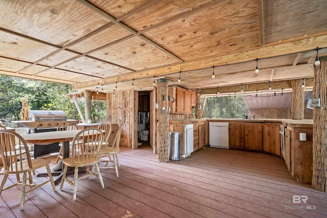 exterior space with grilling area, a sink, and outdoor dining space