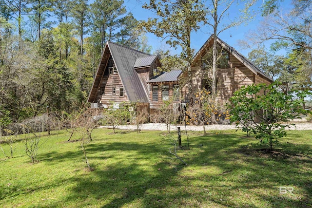 a-frame home with a front lawn, metal roof, and a standing seam roof