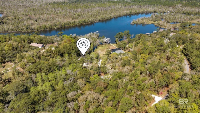 aerial view with a water view and a wooded view
