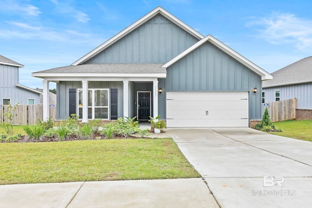 view of front of property featuring a front yard and a garage