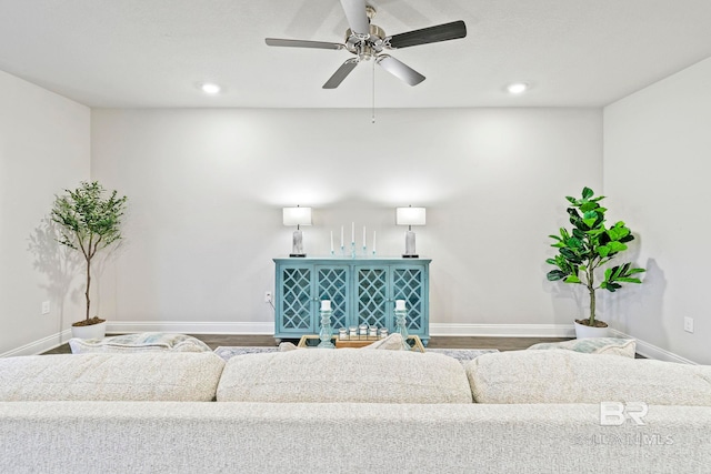 living room with ceiling fan and wood-type flooring