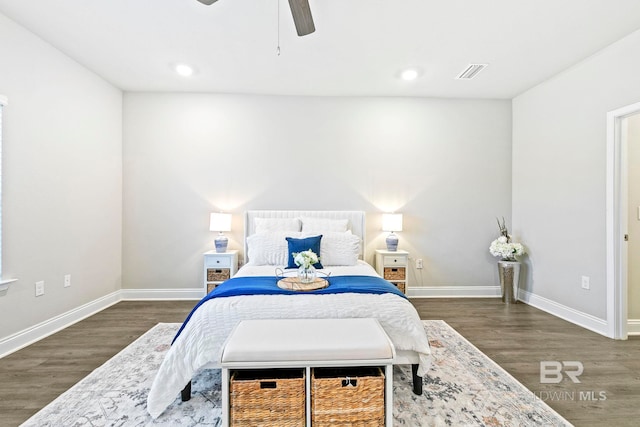 bedroom with dark hardwood / wood-style floors and ceiling fan