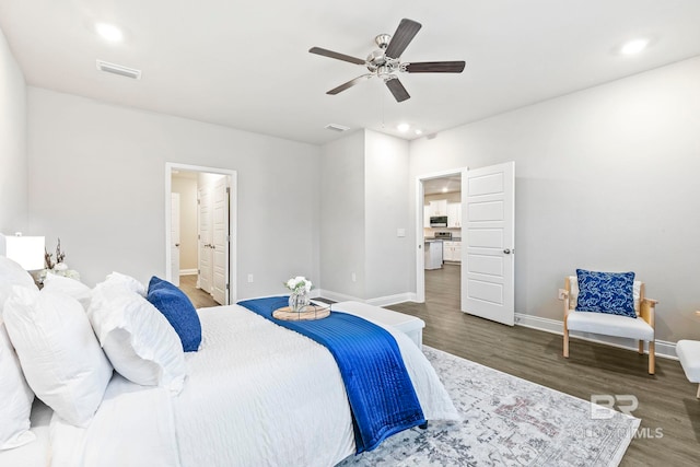 bedroom featuring connected bathroom, ceiling fan, and dark hardwood / wood-style flooring