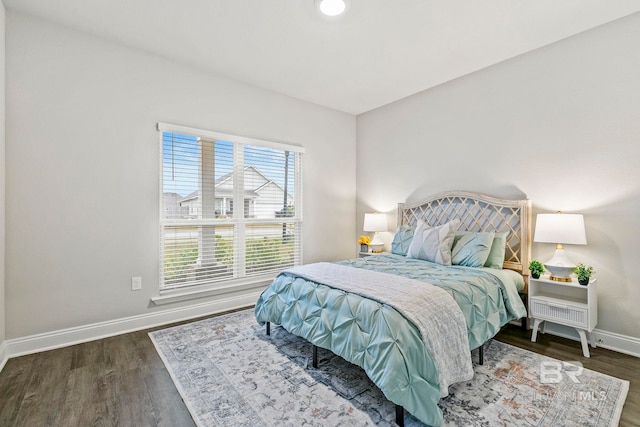 bedroom with dark hardwood / wood-style floors