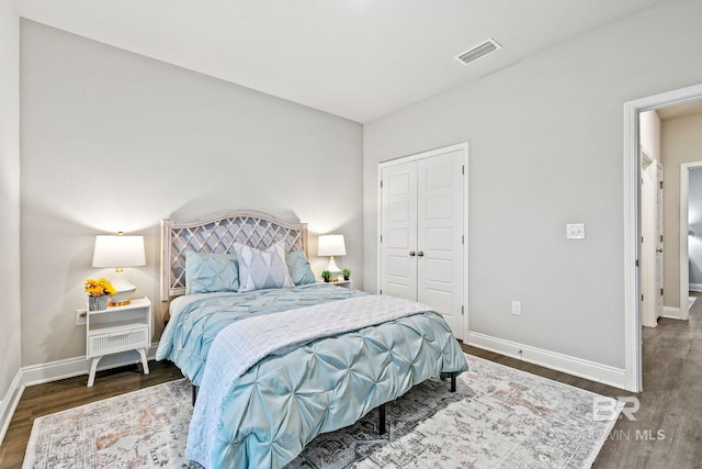 bedroom with a closet and dark hardwood / wood-style flooring