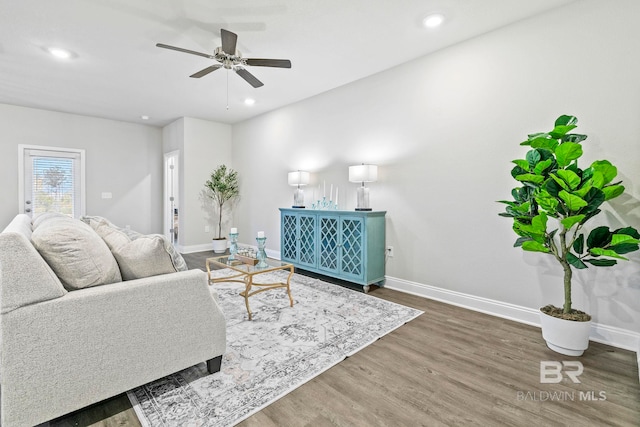 living room with ceiling fan and dark hardwood / wood-style floors