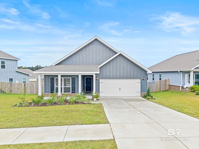 view of front of home with a garage and a front lawn