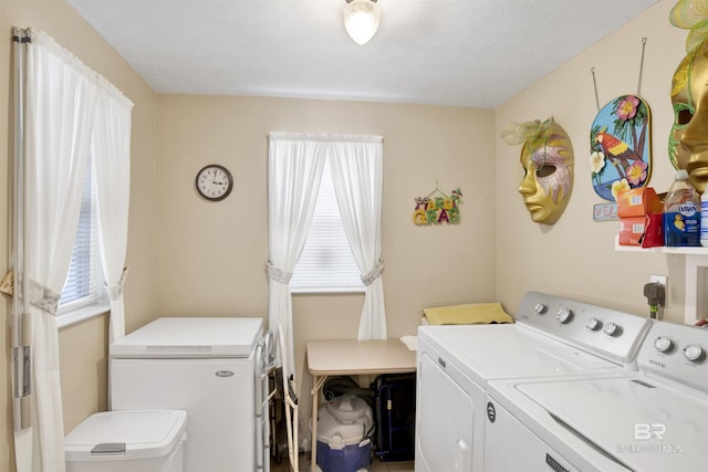 clothes washing area featuring independent washer and dryer