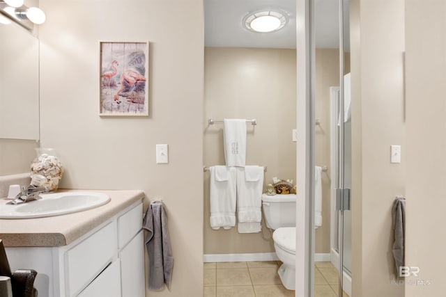 bathroom featuring a shower with door, tile patterned flooring, vanity, and toilet