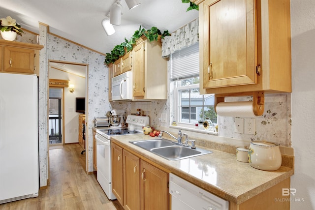 kitchen with white appliances, light hardwood / wood-style floors, ornamental molding, sink, and lofted ceiling