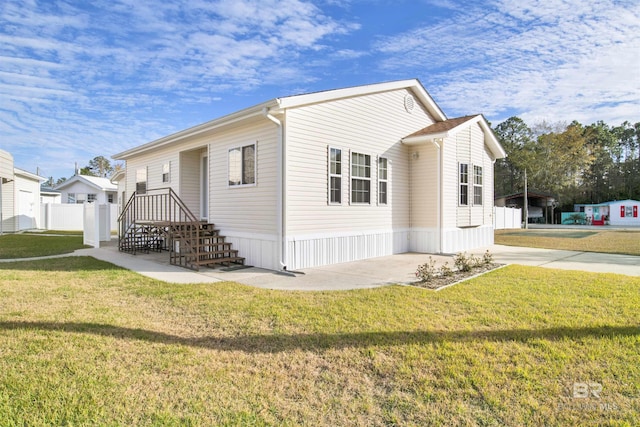 view of property exterior with a patio area and a yard