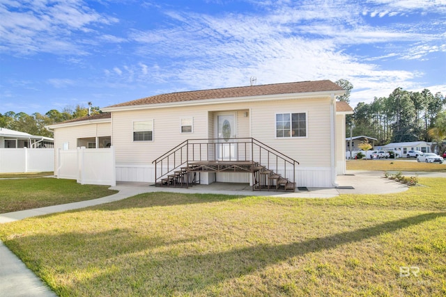 back of house with a lawn