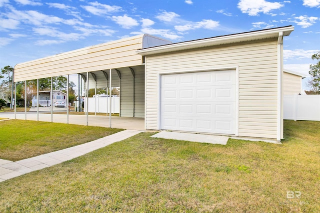 garage featuring a yard and a carport