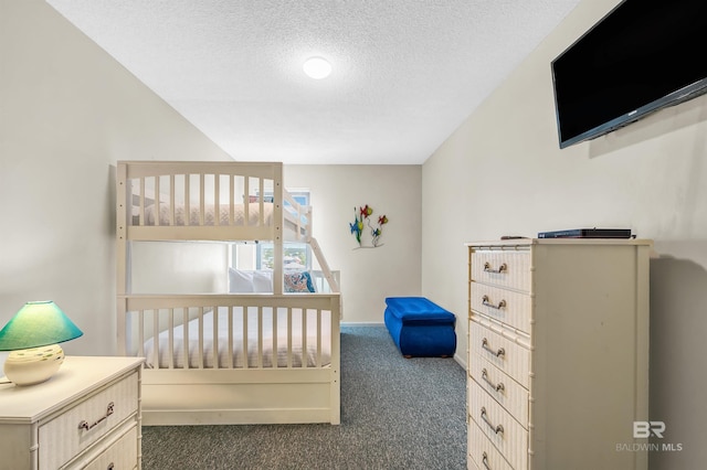 407 W Beach Blvd Unit 570, Gulf Shores, AL 36542 - carpeted bedroom with a textured ceiling and baseboards