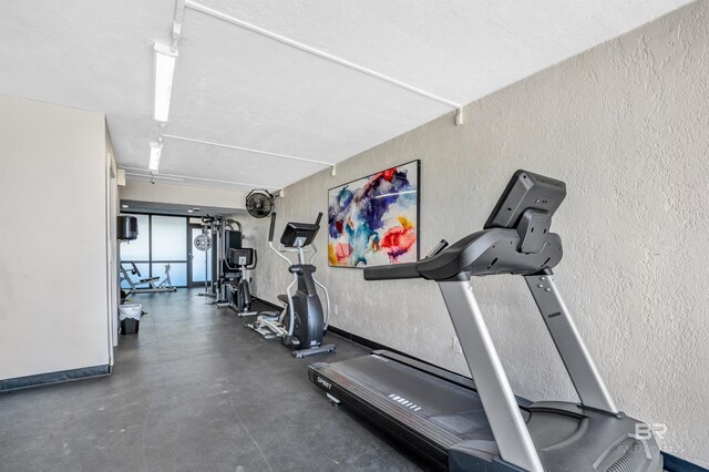 407 W Beach Blvd Unit 570, Gulf Shores, AL 36542 - gym with a textured wall and baseboards