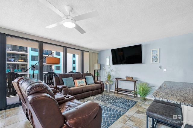407 W Beach Blvd Unit 570, Gulf Shores, AL 36542 - living area with a textured ceiling, a ceiling fan, and baseboards