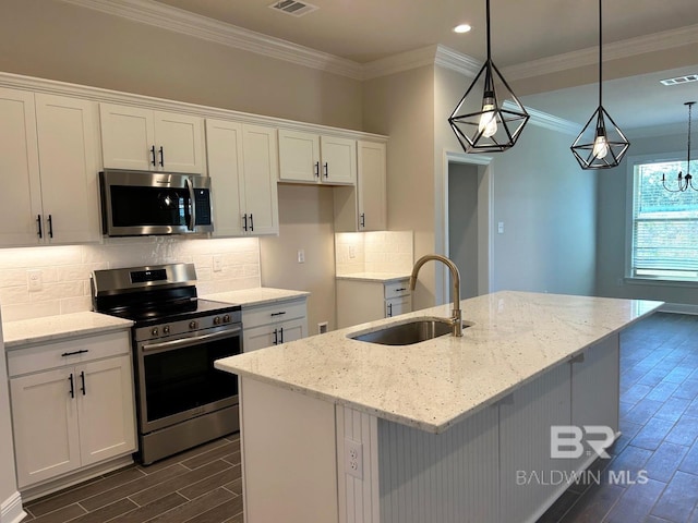 kitchen featuring light stone countertops, white cabinetry, sink, and appliances with stainless steel finishes