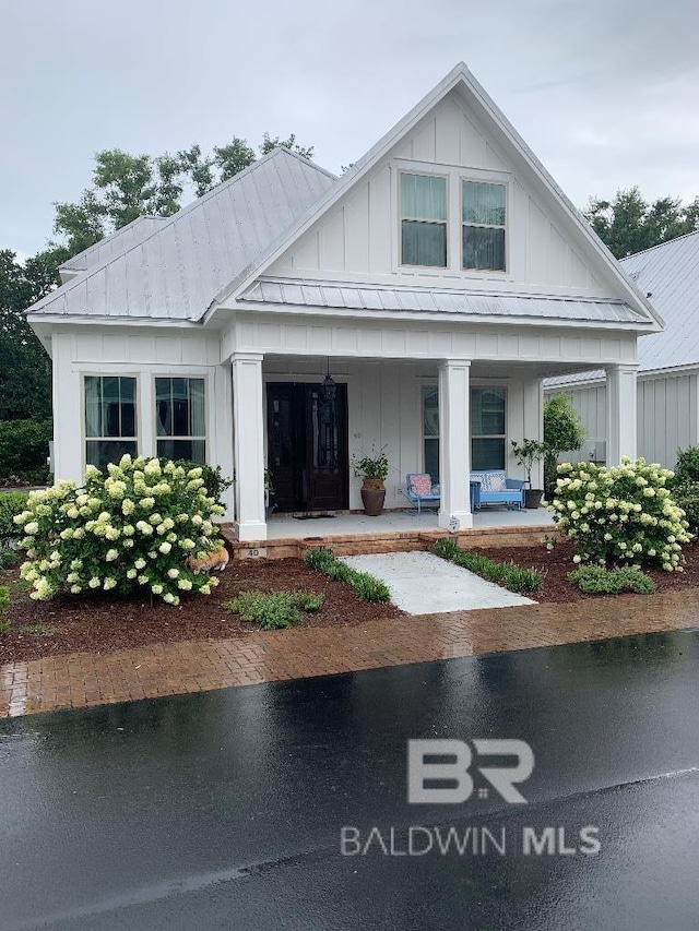 40 Bay Pointe Ct, Fairhope, AL 36532 - view of front facade with board and batten siding, a porch, and metal roof