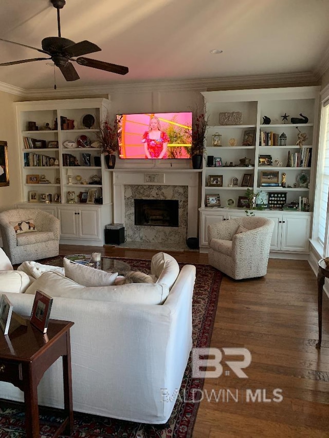 40 Bay Pointe Ct, Fairhope, AL 36532 - living area with ornamental molding, wood finished floors, a high end fireplace, a ceiling fan, and built in features