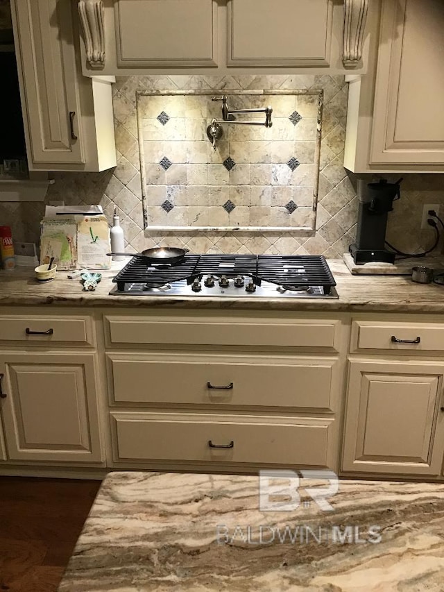 40 Bay Pointe Ct, Fairhope, AL 36532 - kitchen featuring stainless steel gas stovetop, tasteful backsplash, and light stone counters
