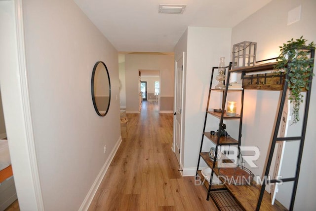 corridor with light hardwood / wood-style flooring