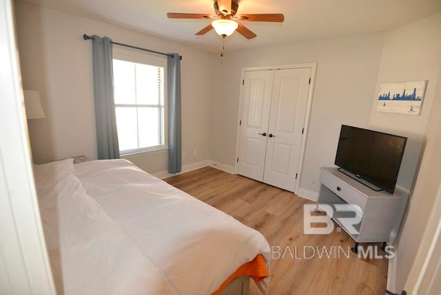 bedroom featuring ceiling fan, a closet, and light wood-type flooring