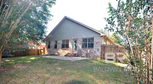 rear view of property with a lawn