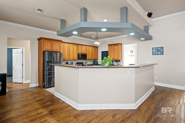 kitchen with ornamental molding, hardwood / wood-style floors, black appliances, and island exhaust hood