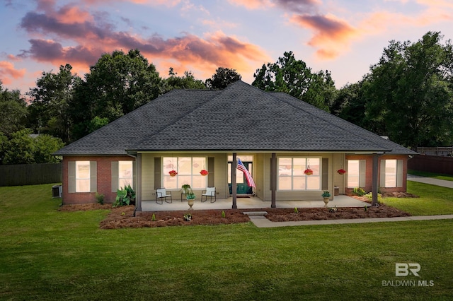 back house at dusk with a yard