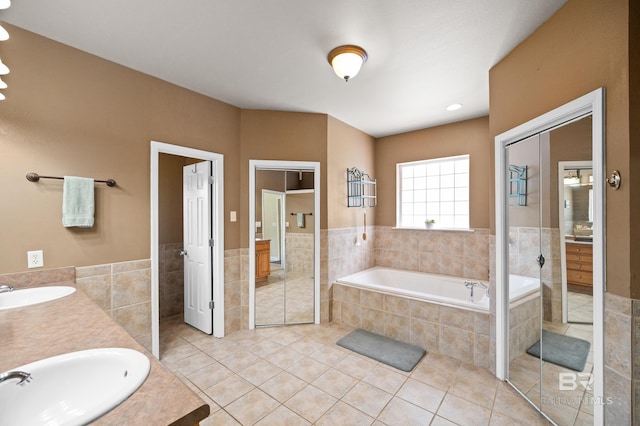 bathroom with vanity, tile patterned flooring, and shower with separate bathtub