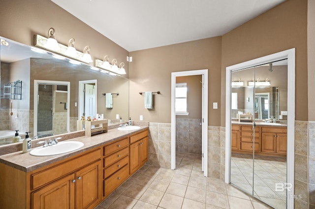 bathroom featuring tile walls, vanity, and tile patterned flooring