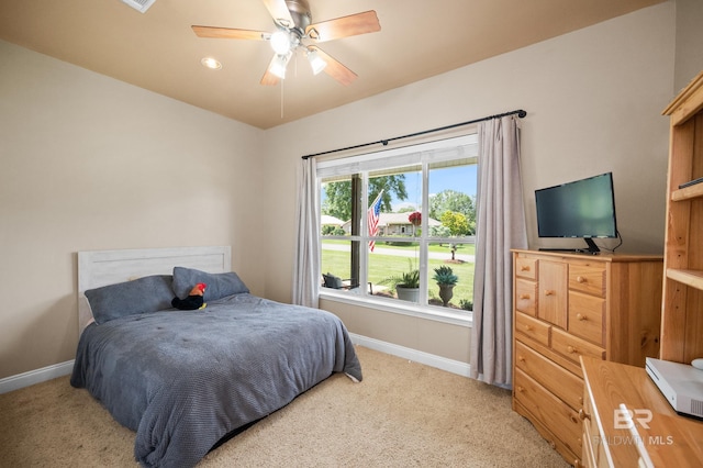 bedroom featuring ceiling fan and light carpet