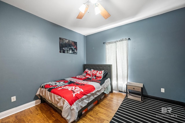 bedroom with ceiling fan and hardwood / wood-style flooring