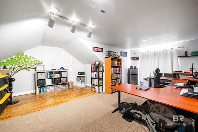 home office featuring vaulted ceiling and carpet flooring