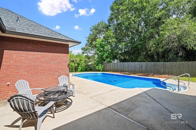 view of pool with a patio and a fire pit