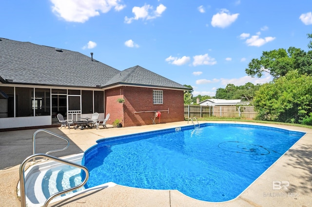 view of pool featuring a sunroom and a patio