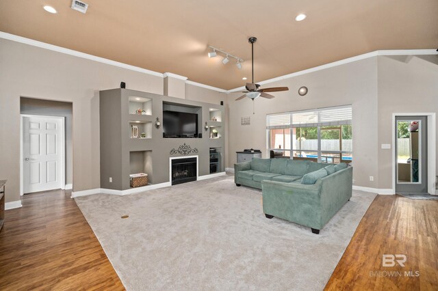 living room featuring ceiling fan, rail lighting, hardwood / wood-style floors, and crown molding