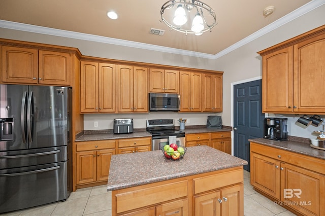 kitchen featuring light tile patterned floors, crown molding, stainless steel appliances, and a center island