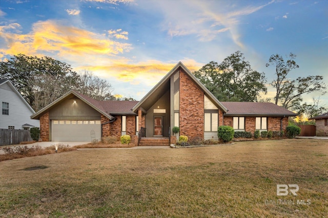 view of front of house featuring a garage and a lawn