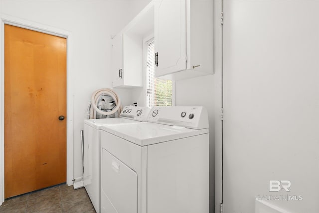 laundry area featuring cabinets, washing machine and clothes dryer, and light tile patterned floors