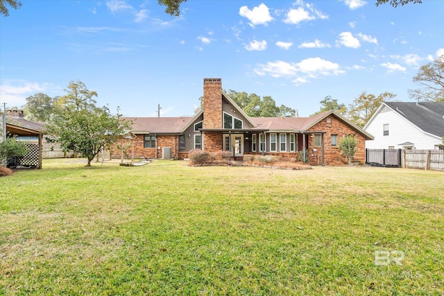 rear view of house with a yard and central air condition unit