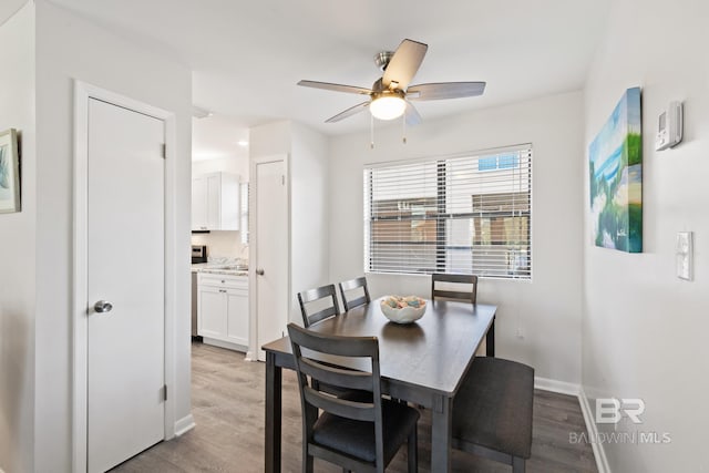 1028 W Beach Blvd Unit 4, Gulf Shores, AL 36542 - dining room featuring light wood-style flooring and ceiling fan