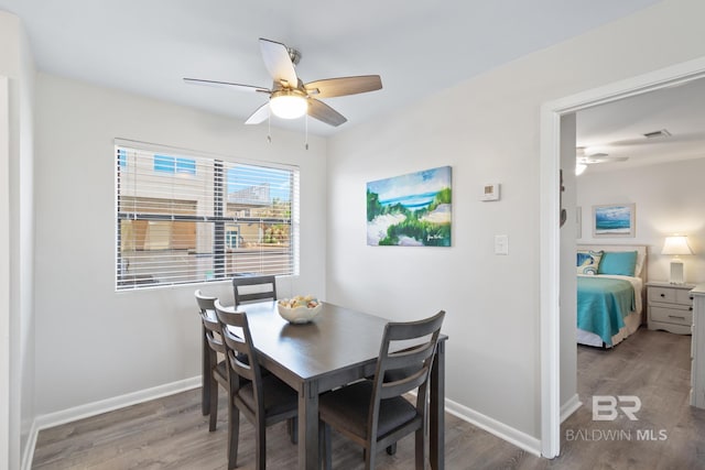 1028 W Beach Blvd Unit 4, Gulf Shores, AL 36542 - dining space featuring a ceiling fan and wood finished floors