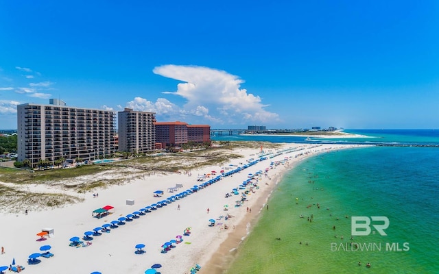 birds eye view of property with a beach view and a water view