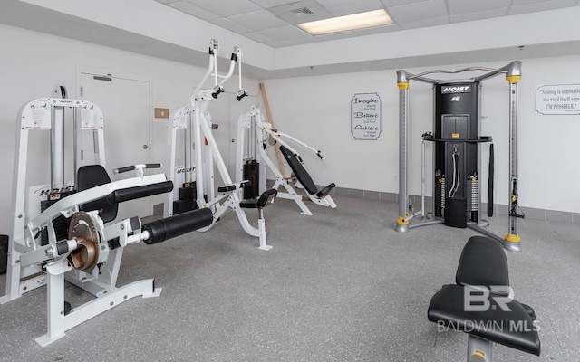 workout area featuring a paneled ceiling