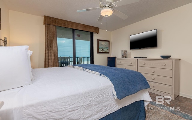 bedroom featuring a textured ceiling, ceiling fan, and access to exterior