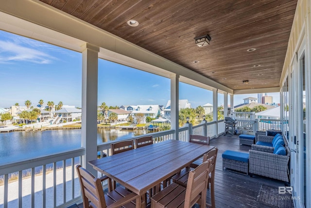 wooden deck featuring a water view