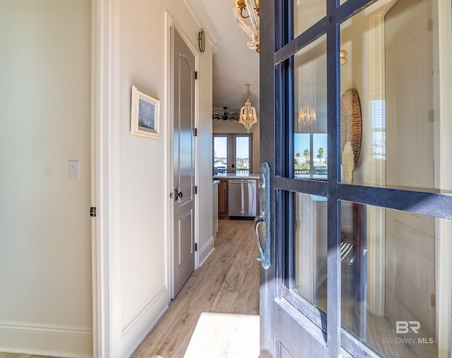 corridor with french doors and light hardwood / wood-style floors