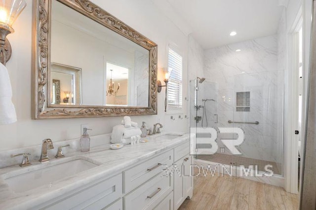 bathroom featuring hardwood / wood-style floors, vanity, and an enclosed shower