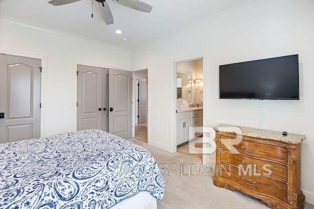 bedroom with ceiling fan, crown molding, light carpet, and ensuite bath